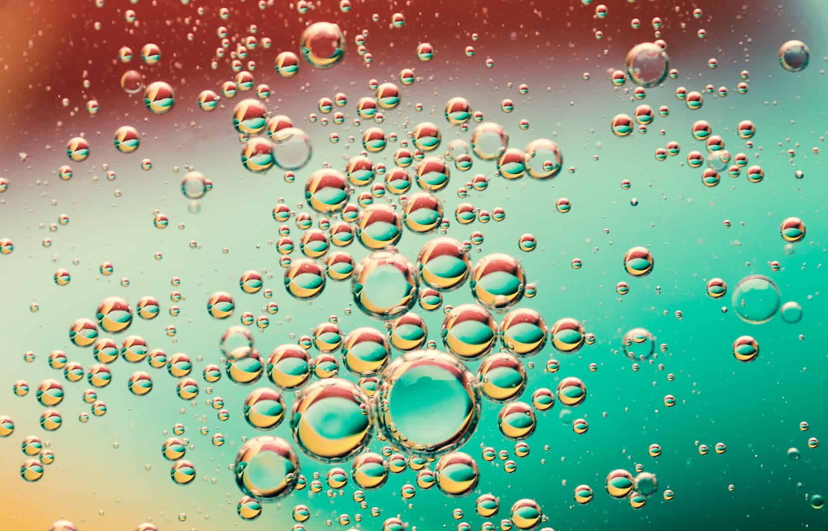 Close-up of numerous colorful water or oil bubbles, visually representing the concept of water becoming more valuable than oil.